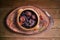Feijoada. Traditional Brazilian food. Ceramic bowl isolated on rustic wooden background. Top view