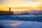 Felgueiras Lighthouse on shore of Atlantic ocean in Porto, Portugal at sunset