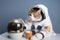 feline astronaut sipping cup of space tea while canine companion floats nearby