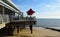 Felixstowe  pier with restaurant parasols beach and sea.