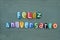 Feliz Aniversario, spanish and portuguese Happy Birthday text composed with colored stone letters