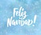 Feliz Navidad - spanish Merry Christmas text. Holiday greetings quote. Blue blurred background with falling snow effect.