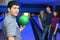 Fellow holds ball for bowling friends hearten him