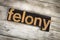 Felony Letterpress Word on Wooden Background