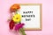 Felt board with text Happy Mother's day, colorful gerberas bouquet on pink backround greeting holiday card Flat lay