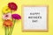 Felt board with text Happy Mother's day, colorful gerberas bouquet on yellow backround greeting holiday card Flat