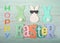 Felt bunnies in earth tone colors in a row Easter sign below