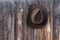 Felt cowboy hat on barn wall