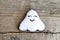 Felt Halloween ghost ornament on old wooden background. Closeup