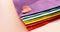 A felt heart rests on a stack of fabric folded in the colors of the LGBT flag. LGBT day concept