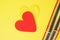 felt hearts and two bracelets with lgbt colors on yellow background copy space top view, pride concept