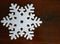 Felt snowflake on wood background