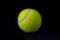 Felt tennis ball on black background. Tennis ball photo for banner template.