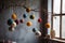 felted ornaments hanging from the tree and creating a warm atmosphere