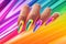 femaile hands with rainbow manicure. Love, valentine, lgbt, pride concept. Rainbow design on long oval nails. Nail art.