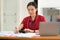 Female accountant analyzing financial reports at office.