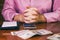 Female accountant counting money with calculator