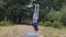 Female acrobat performs hand stand outdoors, balance exercise strong hands slow