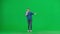 Female activist with raised fist shouting menacingly into megaphone in studio on green screen. Front view of a pro