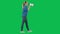 Female activist with raised fist shouting menacingly into megaphone in studio on green screen. Side view of a pro