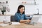 Female adult using portable device in kitchen interior