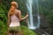 Female adventurer looking at waterfall