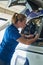 Female Aero Engineer Working On Helicopter In Hangar