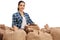 Female agricultural worker with burlap sacks filled with coffee