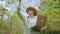 Female agronomist inspecting spoiled bad harvest on vegetable farm. Caucasian woman farmer walks in dried leaves orchard