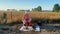 Female agronomy scientist preparing for soil analysis at field sunrise