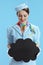 female air hostess on blue showing blank cloud shape board