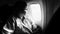 female airplane passanger seeing out of airplane cabin window, black and white high contrast picture style, highlight on woman
