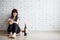 Female alcoholism, relationship, divorce and depression concept - unhappy stressed woman sitting on the floor and drinking wine,