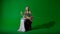 Female in ancient outfit on the chroma key green screen background. Business woman in renaissance dress drinking coffee