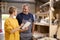 Female Apprentice Learning Skills From Mature Male Carpenter In Furniture Workshop