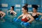 Female aqua aerobics, training with dumbbells