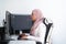 Female Arabic creative professional working at home office on desktop computer with dual screen monitor top view