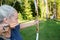 Female Archer Aiming Arrow At Target Board In Forest