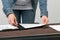 Female Architect clips some floorplans to a clipboard.