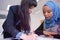 Female Architecture teacher at work. Female professor explain architectural projects to female african student