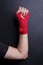 Female arm bandaged red boxing tape