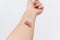 Female arm with different pastel colors on skin on white background. Modern makeup colors, home manicure. Female hand raised up