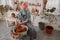 Female artisan concentrated on modeling bowl in workroom