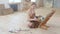 Female artist painting picture sitting on the floor, slow motion