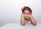 Female asian child girl posing wacky sad lonely pose while wearing some accessories like crown, necklace, pink eye glasses and