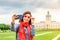 Female asian tourist in the baroque garden in front of the ancient architecture of royal Charlottenburg palace. Sightseeing