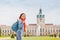 Female asian tourist in the baroque garden in front of the ancient architecture of royal Charlottenburg palace. Sightseeing