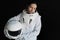 Female astronaut on a black background. Fantastic space suit. Exploration of outer space.