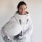 Female astronaut on a white background. Fantastic space suit. Exploration of outer space.