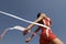 Female Athlete Crossing Finish Line Against Blue Sky